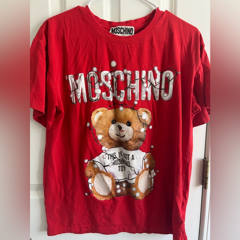 Red bear shirt, adorned with small colorful lights.